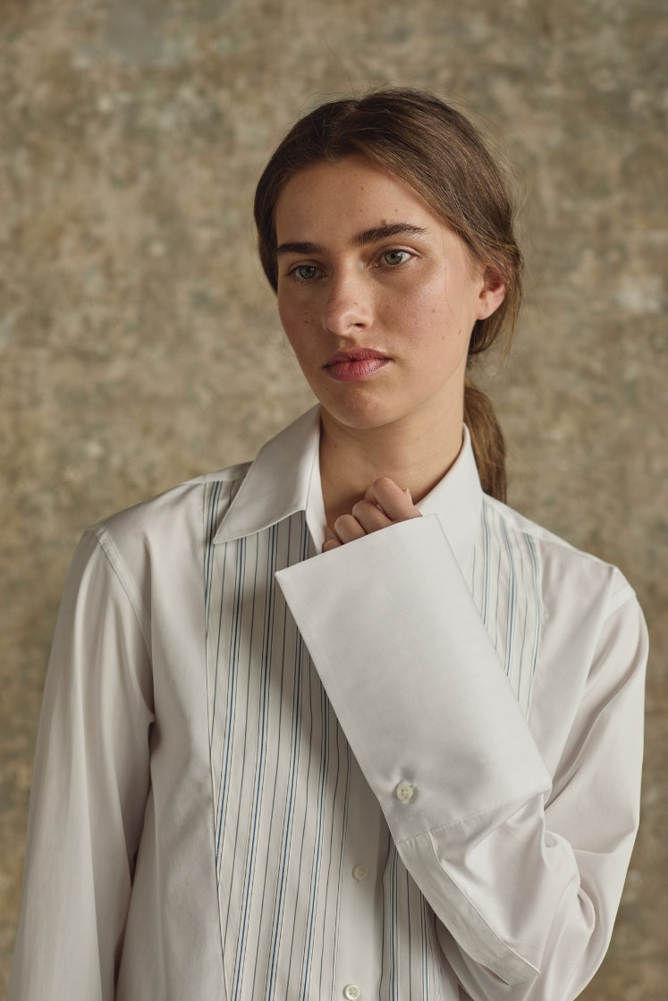 Femme portant chemise blanche à plastron Bourrienne Paris X, détails artisanaux raffinés, élégance intemporelle française