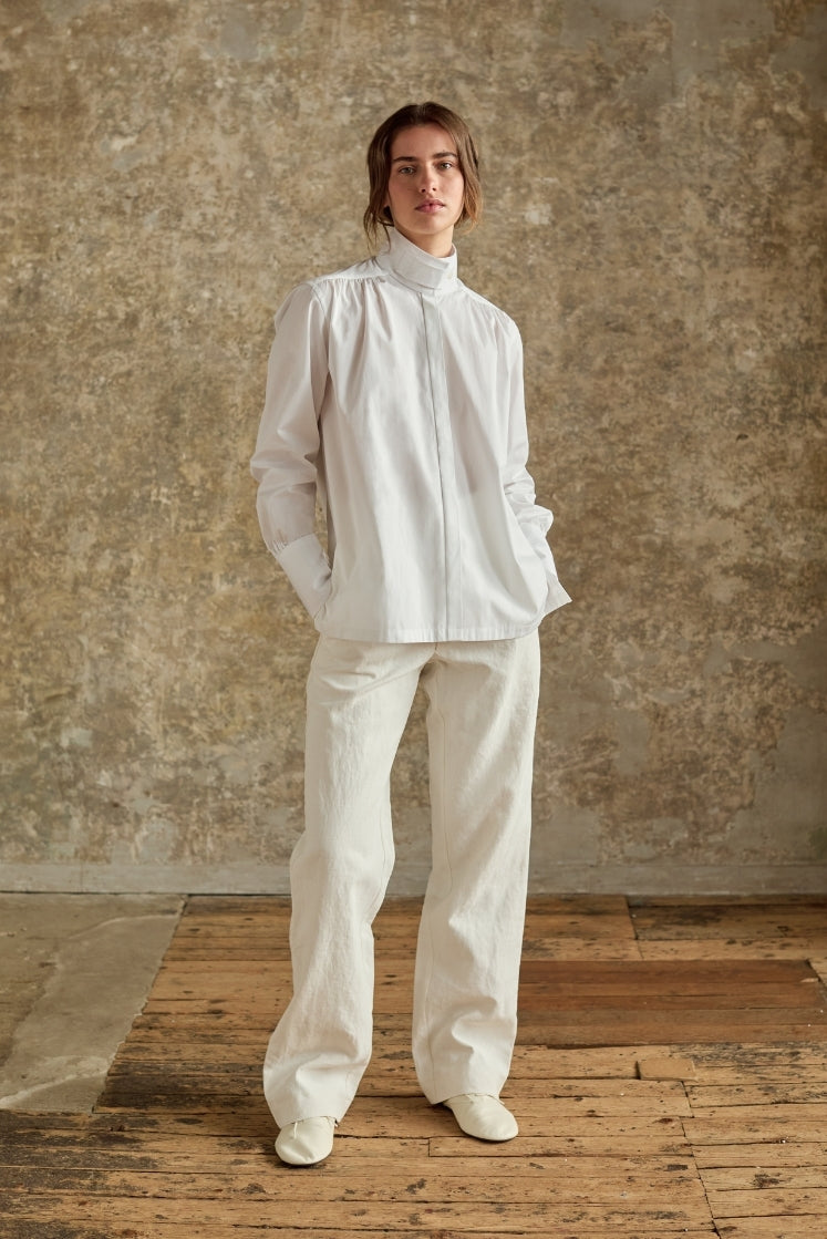 Chemise blanche col haut Bourrienne Paris, pantalon en lin platré, silhouette minimaliste élégante