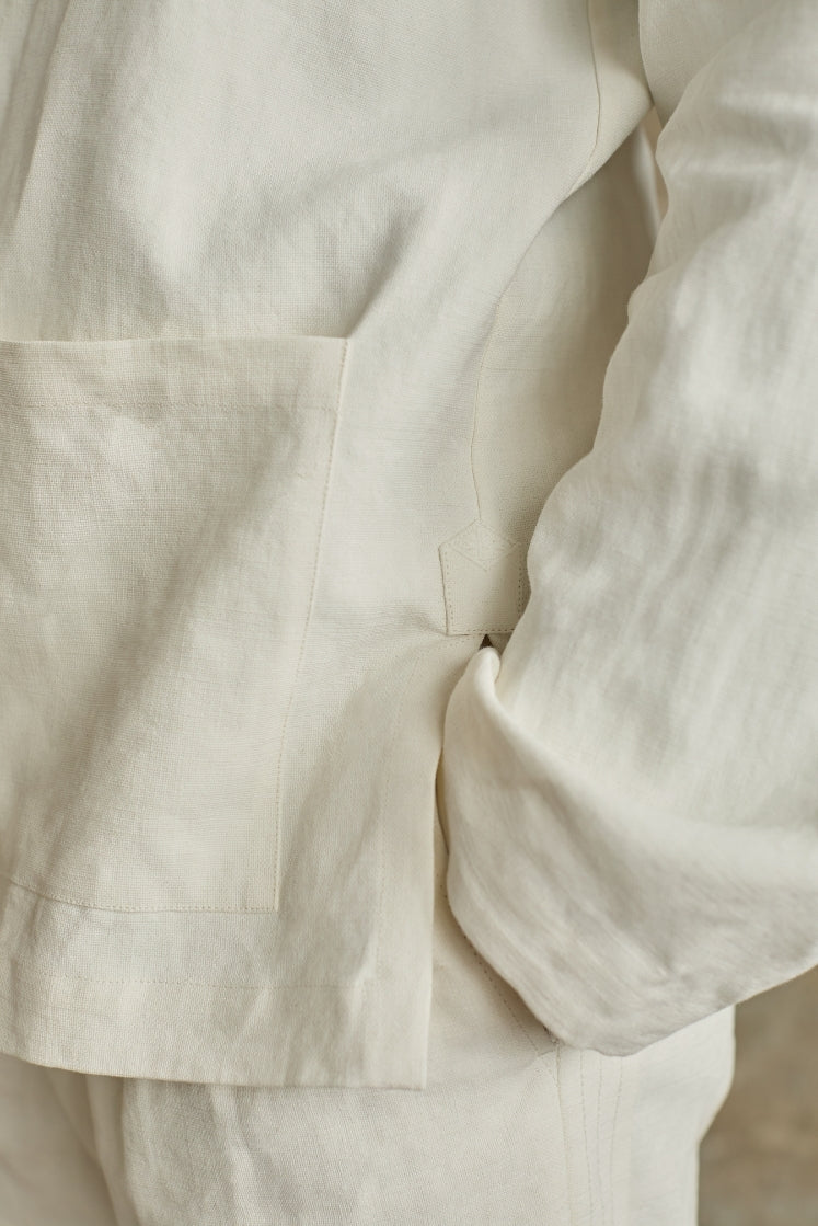 Closeup sur la matière de la veste CHEVALET : le lin plâtré, un lin travaillé artisanalement auquel on ajoute une couche d'apprêt pour un rendu qui évoque les toiles d'artistes, matière signature Bourrienne Paris X